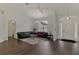 Inviting living room with dark wood floors, lots of light, and a view of the front entrance and a large window at 4038 Corydon Ave, North Port, FL 34286