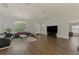 Spacious living room featuring a chandelier, ceiling fan, light walls, and dark floors for a welcoming ambiance at 4038 Corydon Ave, North Port, FL 34286