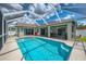 Stunning pool with pristine water, a spacious patio, screened enclosure, and inviting lounge area at 4038 Corydon Ave, North Port, FL 34286