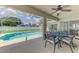Sparkling pool with screened enclosure, lush greenery, and a view of the fenced backyard at 4038 Corydon Ave, North Port, FL 34286