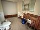 Bathroom showing damage to walls, with the toilet and storage unit still present at 420 W Olympia Ave, Punta Gorda, FL 33950