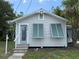 Charming single-story home with a front entrance featuring decorative gable trim at 420 W Olympia Ave, Punta Gorda, FL 33950