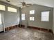 View of a living room needing renovation with two windows and french doors at 420 W Olympia Ave, Punta Gorda, FL 33950