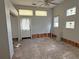 Damaged living room with unique stained glass windows and lots of natural light at 420 W Olympia Ave, Punta Gorda, FL 33950
