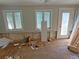 Living room needing renovation with large windows at 420 W Olympia Ave, Punta Gorda, FL 33950