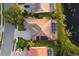 Aerial view featuring a backyard with pool, screened-in lanai, meticulous landscaping, and calming lake at 4334 Corso Venetia Blvd, Venice, FL 34293
