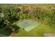 Aerial view of community basketball court and hopscotch area surrounded by green grass and trees at 4334 Corso Venetia Blvd, Venice, FL 34293