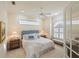 Cozy bedroom boasts a comfortable bed, stylish furniture, and plenty of natural light at 4334 Corso Venetia Blvd, Venice, FL 34293