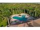 Aerial view showcasing a beautiful community pool with palm trees, lounge chairs, and pristine landscaping at 4334 Corso Venetia Blvd, Venice, FL 34293