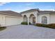 Lovely home featuring an attached two car garage and a paved brick driveway at 4334 Corso Venetia Blvd, Venice, FL 34293