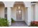 Beautiful front entry featuring a brick entry, decorative glass door, and lush landscaping at 4334 Corso Venetia Blvd, Venice, FL 34293