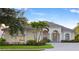 Charming home boasts lush landscaping, a well-manicured lawn, and an inviting front entrance at 4334 Corso Venetia Blvd, Venice, FL 34293