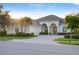Beautiful home with a tile roof, arched entryway, and professional landscaping at 4334 Corso Venetia Blvd, Venice, FL 34293