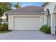 Attached garage with lights and paver driveway at 4334 Corso Venetia Blvd, Venice, FL 34293