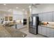 Modern kitchen with granite counters, stainless steel appliances, and ample cabinet space at 4334 Corso Venetia Blvd, Venice, FL 34293