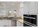Gourmet kitchen featuring stainless appliances, granite counters, and a beautiful view of the water at 4334 Corso Venetia Blvd, Venice, FL 34293