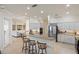 Bright kitchen with stainless steel appliances, granite countertops, and breakfast bar seating at 4334 Corso Venetia Blvd, Venice, FL 34293