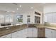 Kitchen featuring granite countertops, stainless steel appliances, and an open view of the backyard at 4334 Corso Venetia Blvd, Venice, FL 34293
