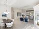 Open concept living area with stylish furnishings, tray ceilings, and seamless transition to the dining room at 4334 Corso Venetia Blvd, Venice, FL 34293