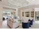 Spacious living room featuring built-in shelving, comfortable seating, and scenic views through sliding glass doors at 4334 Corso Venetia Blvd, Venice, FL 34293
