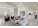 Open-concept living area with tile flooring, stylish sofas, and a view of the dining area and kitchen at 4334 Corso Venetia Blvd, Venice, FL 34293