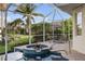 The screened pool with spa and outdoor dining offers a relaxing retreat with picturesque landscaping and serene lake views at 4334 Corso Venetia Blvd, Venice, FL 34293