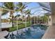 The screened-in pool area features a spa and an outdoor dining set, offering a tranquil space for leisure and gatherings at 4334 Corso Venetia Blvd, Venice, FL 34293