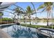 Beautiful screened pool boasts tropical landscaping, scenic lake views, and a relaxing spa, creating a private outdoor oasis at 4334 Corso Venetia Blvd, Venice, FL 34293