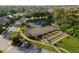Aerial view of community tennis and bocce ball courts surrounded by lush landscaping at 4334 Corso Venetia Blvd, Venice, FL 34293