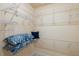 Bright walk-in closet features white wire shelving and decorative pillows for organizing personal items at 4334 Corso Venetia Blvd, Venice, FL 34293