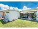 Large backyard with a storage shed and a covered patio area, perfect for outdoor relaxation at 720 Dalton Blvd, Port Charlotte, FL 33952