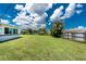 Expansive backyard with lush green grass, mature trees, and partial fencing, offering ample space at 720 Dalton Blvd, Port Charlotte, FL 33952