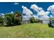 Expansive backyard with lush greenery, mature trees, and a fenced perimeter at 720 Dalton Blvd, Port Charlotte, FL 33952