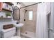 Bathroom featuring new tile, black fixtures, and open shelving for ample storage space at 720 Dalton Blvd, Port Charlotte, FL 33952