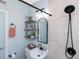Bathroom featuring new tile, black fixtures, and open shelving for ample storage space at 720 Dalton Blvd, Port Charlotte, FL 33952
