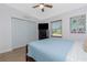 Comfortable bedroom featuring wood-look floors, ceiling fan, a flat screen TV, and beach decor at 720 Dalton Blvd, Port Charlotte, FL 33952