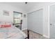 Bright bedroom with a beachy theme, showcasing a cozy bed, closet, and seaside decor at 720 Dalton Blvd, Port Charlotte, FL 33952