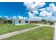 Well-maintained home with a lush green lawn and neatly trimmed landscaping, showcasing curb appeal at 720 Dalton Blvd, Port Charlotte, FL 33952
