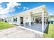 Charming single-story home featuring a covered carport and well-maintained front yard at 720 Dalton Blvd, Port Charlotte, FL 33952