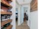 Hallway with view to cozy bedroom featuring wood-look floors and blue color accents at 720 Dalton Blvd, Port Charlotte, FL 33952