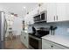 Modern kitchen featuring stainless steel appliances, white countertops, blue backsplash and eat-in kitchen at 720 Dalton Blvd, Port Charlotte, FL 33952