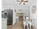 Open-concept kitchen and dining area with stainless steel appliances and seating for four at 720 Dalton Blvd, Port Charlotte, FL 33952