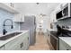Modern kitchen with stainless steel appliances, white countertops, blue backsplash and eat-in kitchen at 720 Dalton Blvd, Port Charlotte, FL 33952