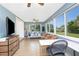 Inviting living space with tile floors, comfortable seating, desk area, and large windows for natural light at 720 Dalton Blvd, Port Charlotte, FL 33952
