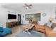 Cozy living room with stylish furnishings, a ceiling fan, and a welcoming atmosphere, perfect for relaxation at 720 Dalton Blvd, Port Charlotte, FL 33952