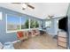 Inviting living area with tile floors, large windows offering natural light, and comfortable rattan seating at 720 Dalton Blvd, Port Charlotte, FL 33952