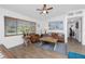 Bright living room featuring wood-look floors, natural light, and a comfortable seating arrangement for entertaining guests at 720 Dalton Blvd, Port Charlotte, FL 33952