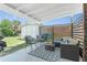 Comfortable covered patio setup with seating, privacy screen, and a shed in the backyard at 720 Dalton Blvd, Port Charlotte, FL 33952