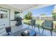 Inviting covered patio with comfortable seating, a grill, and views of the backyard at 720 Dalton Blvd, Port Charlotte, FL 33952