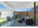 Relaxing covered patio area with comfortable seating, a privacy screen, and a shed at 720 Dalton Blvd, Port Charlotte, FL 33952
